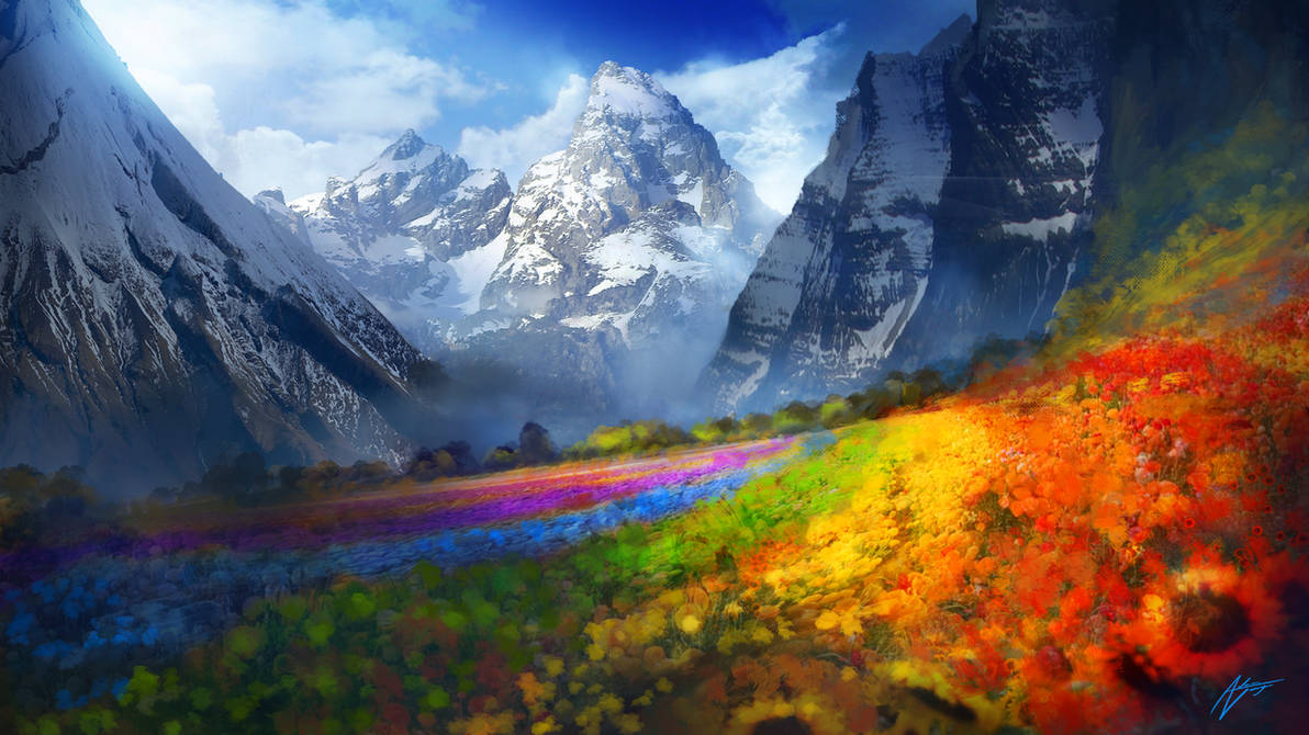 A vibrant field of multicolored flowers stretches toward snow-covered mountains under a blue sky with scattered clouds.