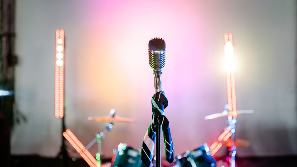 Vintage microphone glowing on a stage with warm bokeh lights