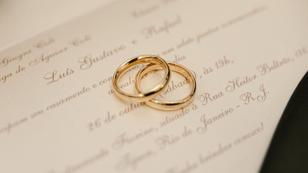 Two gold wedding rings resting together on a soft surface, symbolizing marriage equality