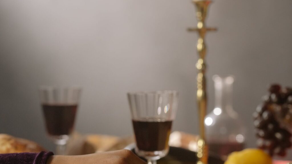 Two hands reaching toward each other across a candlelit table
