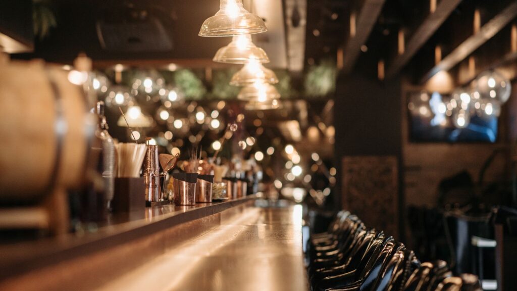 Cozy bar interior glowing with warm, inviting light